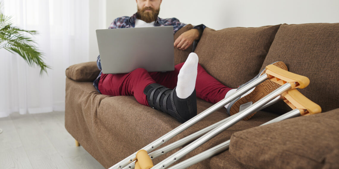 Injured man using laptop