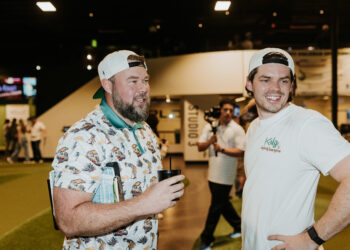 Austin Kurtz and Brian Riley co founders of KRLG injury lawyers talking at Putting World in Scottsdale